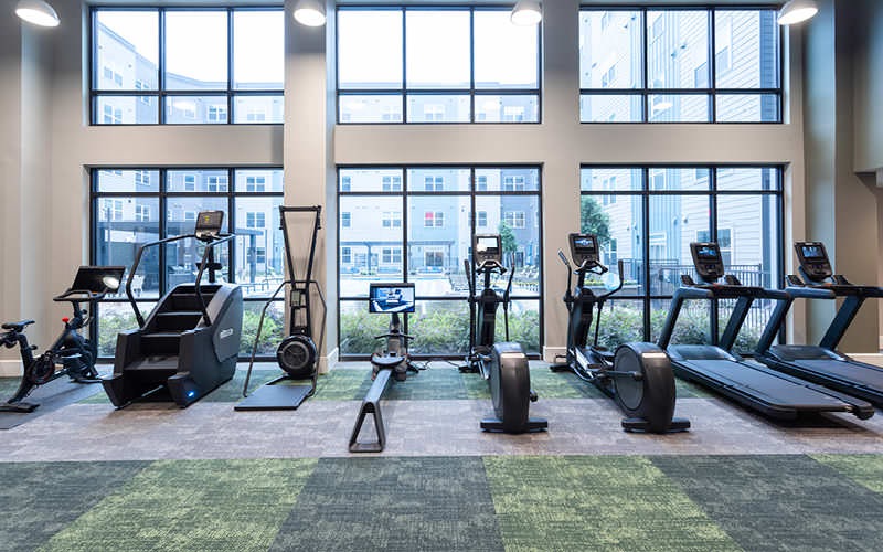 spacious fitness center with high ceiling