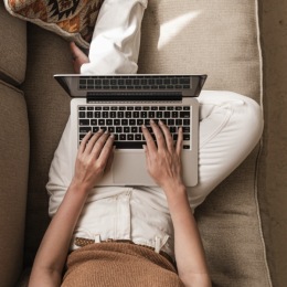 a woman typing on a laptop
